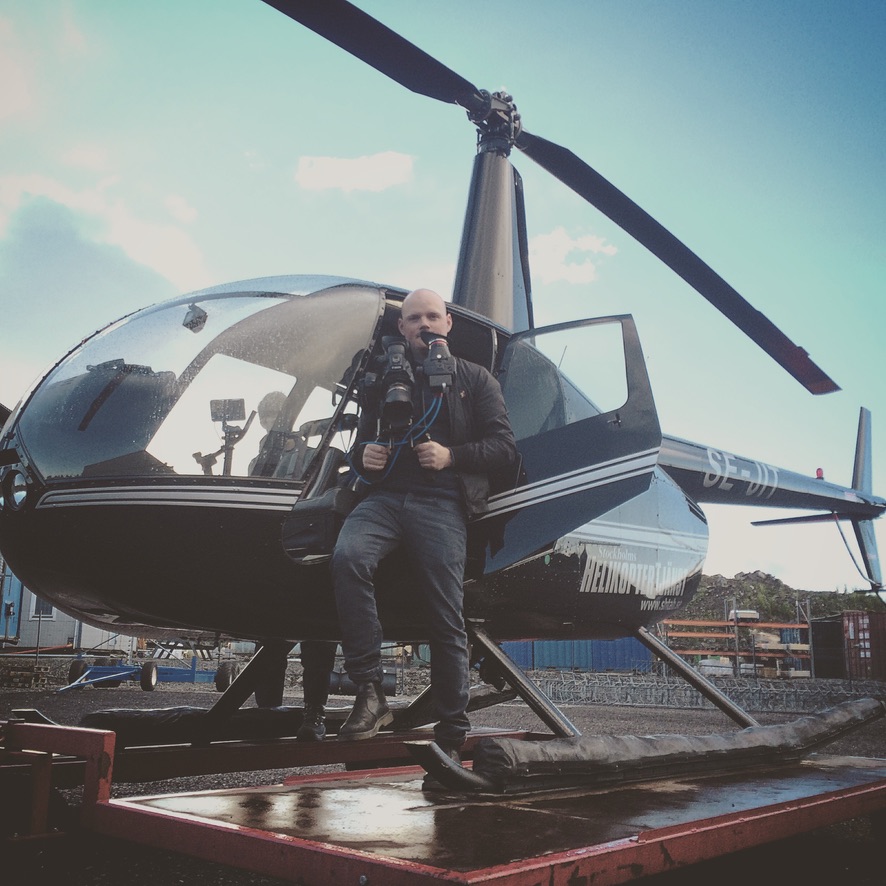 With a camera rig beside the helicopter