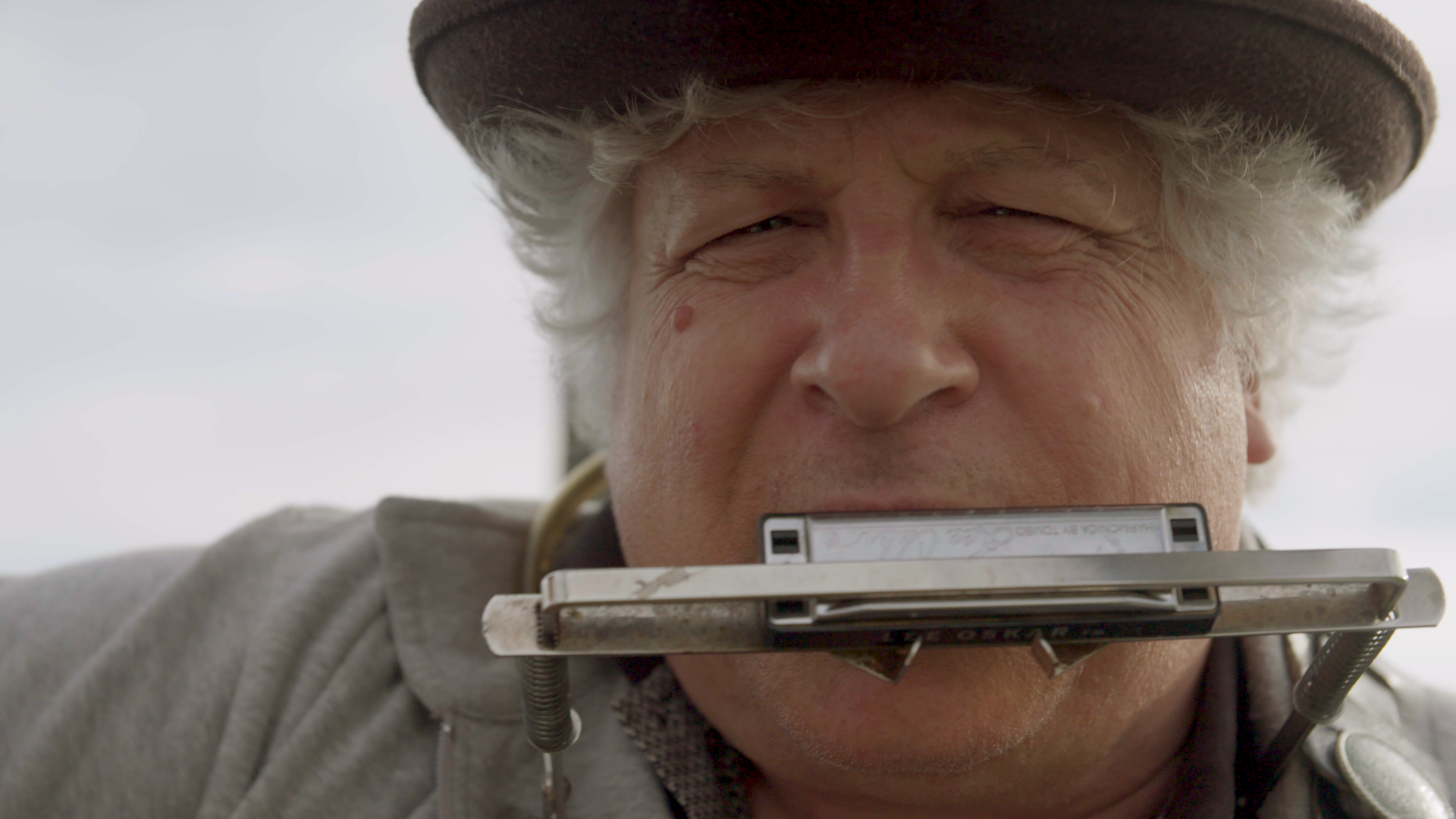 Close portrait of a harmonica player